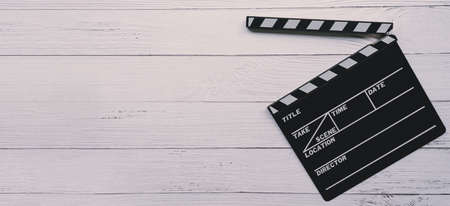 Close up of a vintage wood clapboard on wood background.の写真素材