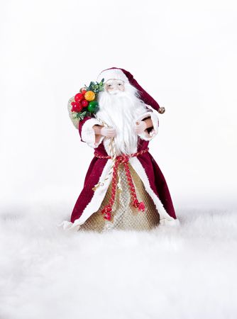 Happy Christmas toy Santa. It is isolated above a white backgroundの写真素材