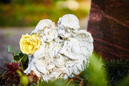 sad angels on grave / Angels feel sorrowの写真素材