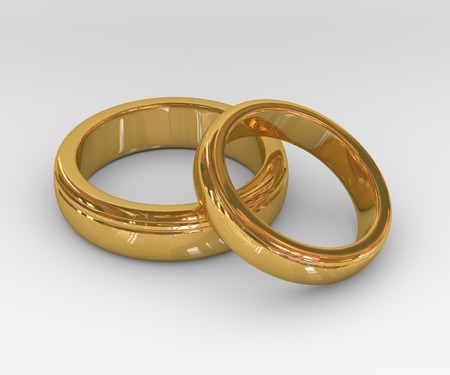 Two golden wedding rings on white background の写真素材
