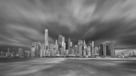 New York City Manhattan downtown skyline in evening with stormy skyの写真素材