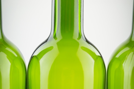 empty green wine bottles isolated on whiteの写真素材