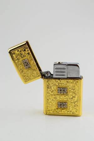 An old used luxurious gold open lighterの写真素材