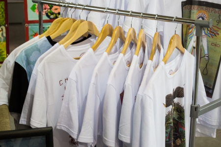  white t shirts on cloth hangers in rowの写真素材