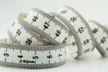 Measure tape or centimeter isolated over whiteの写真素材