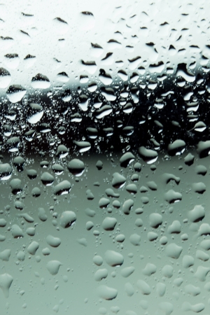 close up of water drops on glass surfaceの写真素材