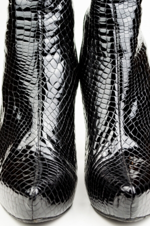 Black female crocodile boots isolated on whiteの写真素材