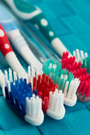 colorful toothbrushes isolated on blue backgroundの写真素材