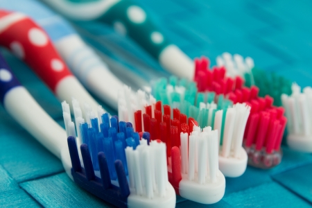 colorful toothbrushes isolated on blue backgroundの写真素材
