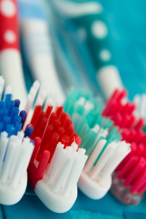 colorful toothbrushes isolated on blue backgroundの写真素材