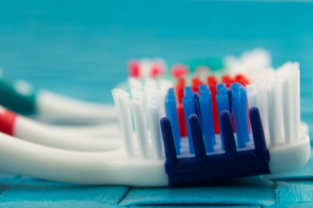 colorful toothbrushes isolated on blue backgroundの写真素材