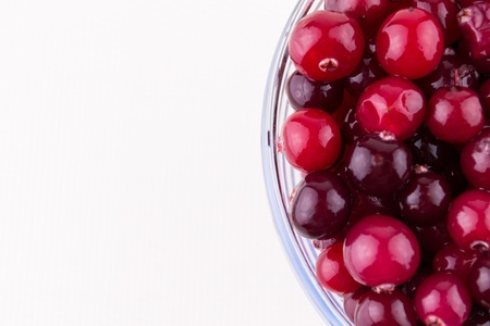 Glass bowl with cranberries on white backgroundの写真素材