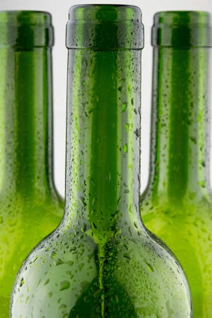  empty green wine bottles isolated on white backgroundの写真素材