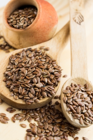 close up of flax seeds in a wooden spoonの写真素材