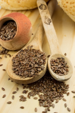 close up of flax seeds in a wooden spoonの写真素材