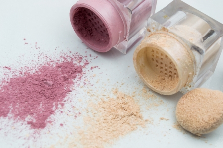 broken eyeshadow palette with brush on white の写真素材