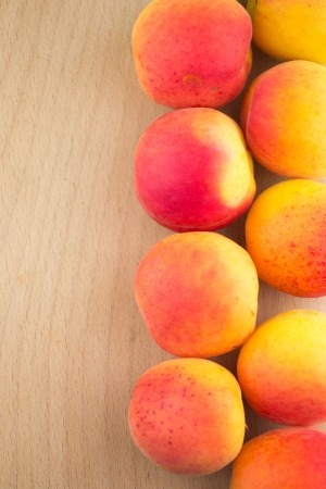 Fresh natural apricot in a row to backgroundの写真素材