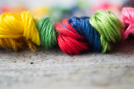 Colorful cotton craft threads on wood background with copy space の写真素材
