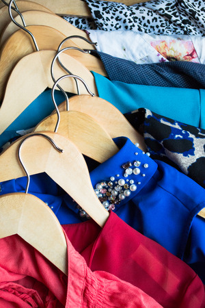 Different clothes on hangers close upの写真素材