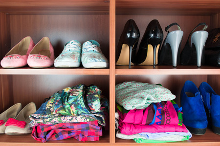 Clothes neatly folded on shelvesの写真素材