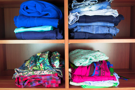 Clothes neatly folded on shelves
