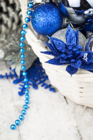 Blue Christmas balls in white wooden basket on whiteの写真素材