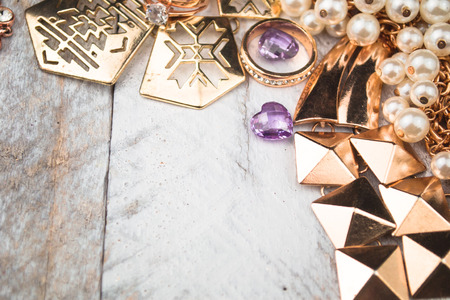Gold jewelry for elegant women on white wood backgroundの写真素材