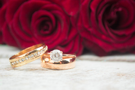 Wedding rings. Red rosesの写真素材
