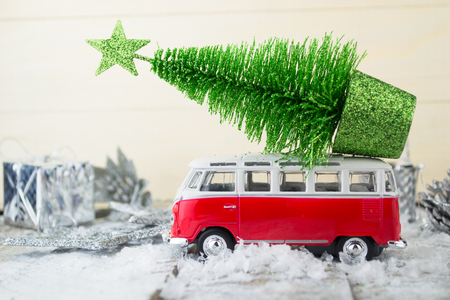 Miniature red car with fir tree on abstract backgroundの写真素材