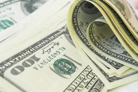 Close-up view of stack of US dollarsの写真素材
