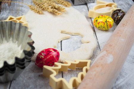 Easter baking preparation. Raw dough and form for the holiday cookies on a wood table.の写真素材