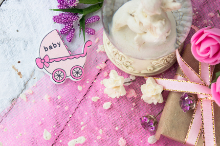 Pink wooden carriage figure with wrapped presents. Girl birth conceptの写真素材