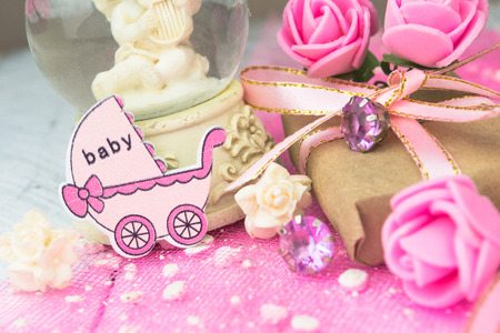 Pink wooden carriage figure with wrapped presents. Girl birth conceptの写真素材