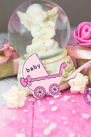 Pink wooden carriage figure with wrapped presents. Girl birth conceptの写真素材