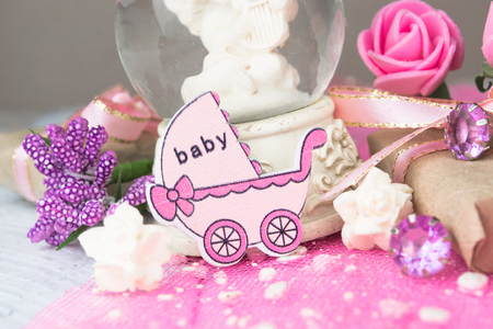 Pink wooden carriage figure with wrapped presents. Girl birth conceptの写真素材