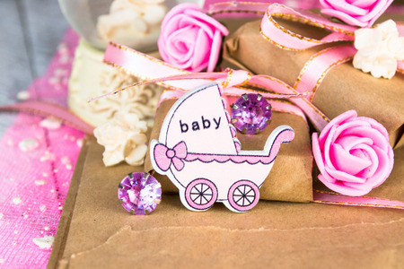 Pink wooden carriage figure with wrapped presents. Girl birth conceptの写真素材