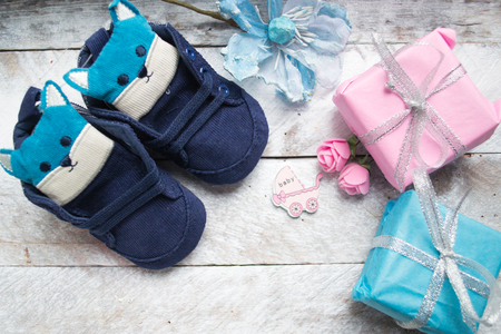 Little baby shoes on a wood