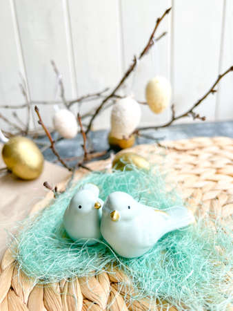 Easter decoration with eggs and birds on a wooden background. Selective focus.の写真素材