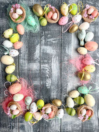 Easter eggs on rustic wooden background. Top view with copy spaceの写真素材