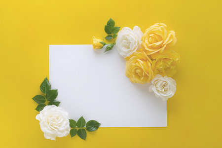 floral frame made with roses on yellow background with copy spaceの写真素材