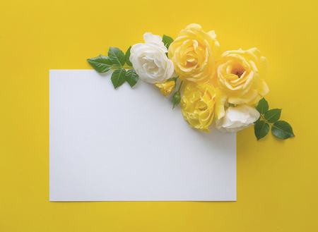 floral frame made with roses on yellow background with copy spaceの写真素材