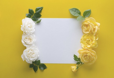 floral frame made with roses on yellow background with copy spaceの写真素材