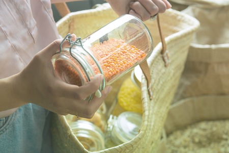 woman is bying products in zero waste shopの写真素材