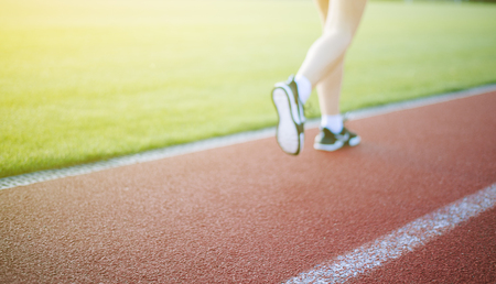 woman is running in the morning in the stadiumの写真素材