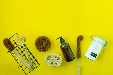 zero waste kit for washing dishers with out plastic on yellow background with copy spaceの写真素材