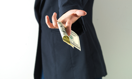 hand is holding, giving, counting american dollars. concept of loan, rich life