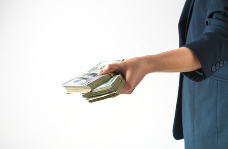 hand is holding, giving, counting american dollars. concept of loan, rich life