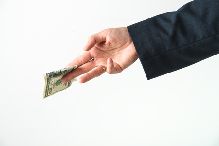 hand is holding, giving, counting american dollars. concept of loan, rich lifeの写真素材