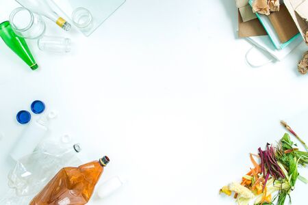 concept of recycling differnt materials glass, paper, food, plastic on white background with coppy...
