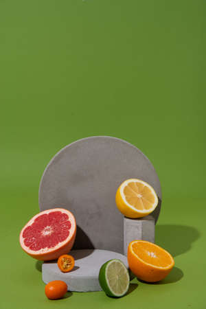 set of citrus fruits on concrete shapes with copy space